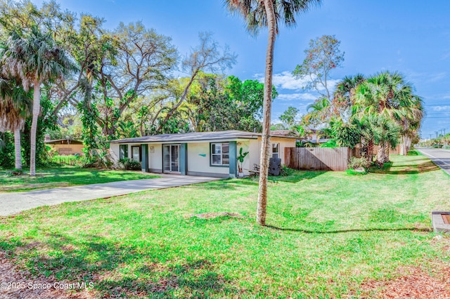 ranch-style home featuring concrete driveway, a front yard, fence, and stucco siding