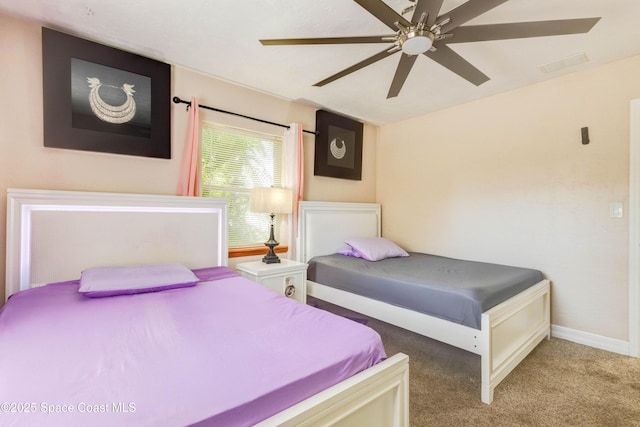 bedroom with carpet, baseboards, and a ceiling fan