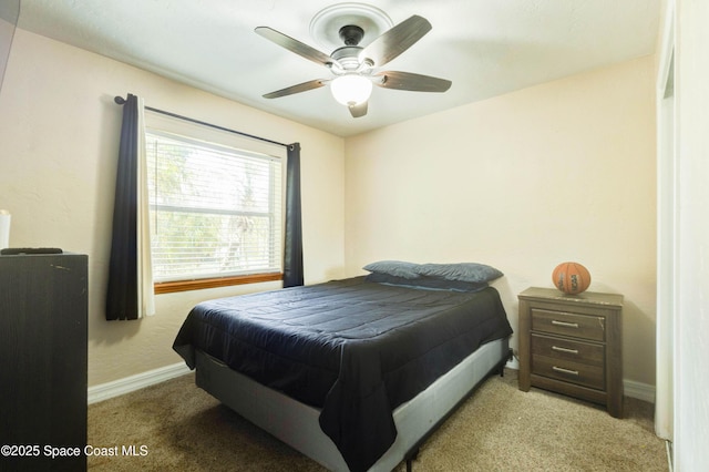 carpeted bedroom with baseboards and a ceiling fan