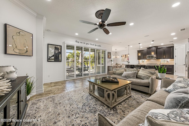 living room featuring visible vents, ornamental molding, a ceiling fan, recessed lighting, and baseboards