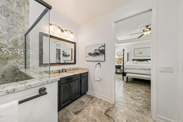 full bath featuring a tile shower, vanity, ensuite bathroom, and ceiling fan