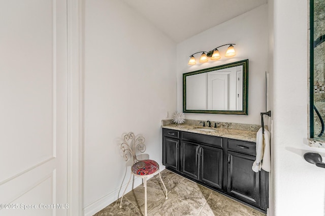 bathroom with vanity and lofted ceiling