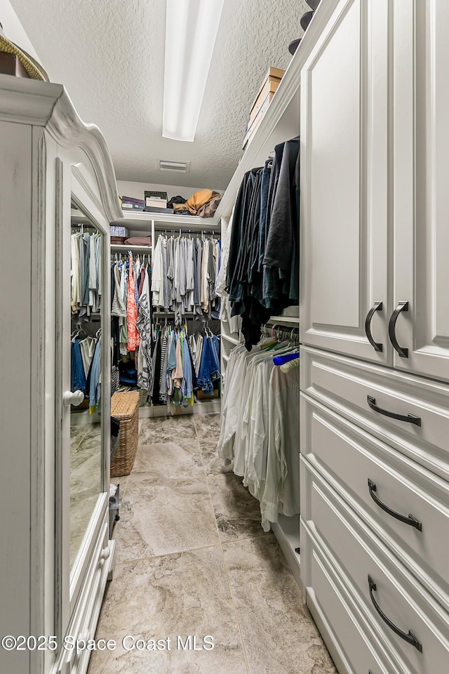 walk in closet with visible vents