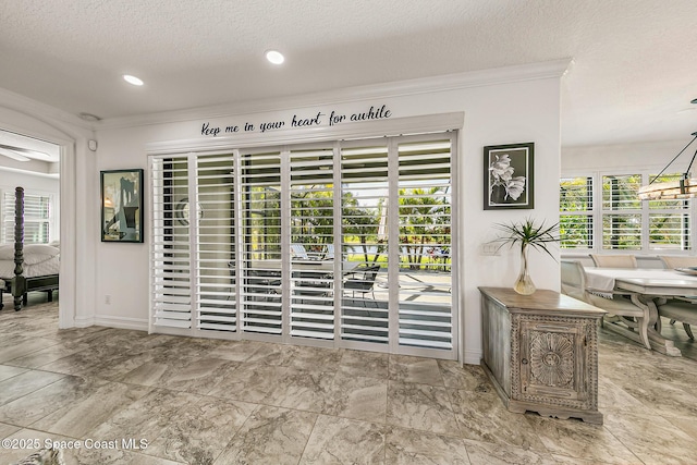 details with recessed lighting, baseboards, a textured ceiling, and ornamental molding