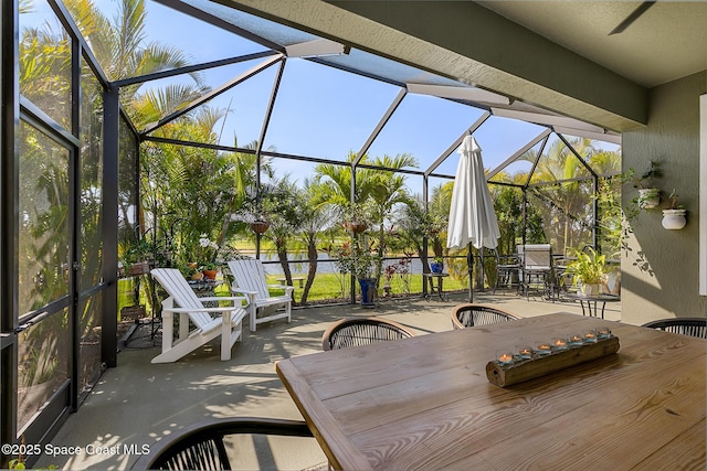 view of patio / terrace with outdoor dining area and a lanai