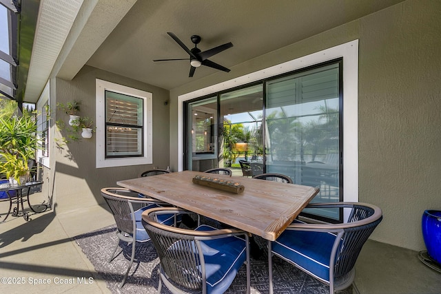 view of patio with outdoor dining space and ceiling fan