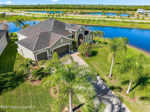 birds eye view of property with a water view