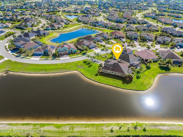 drone / aerial view featuring a residential view and a water view