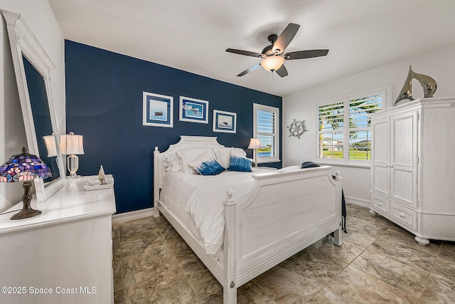 bedroom featuring baseboards and a ceiling fan