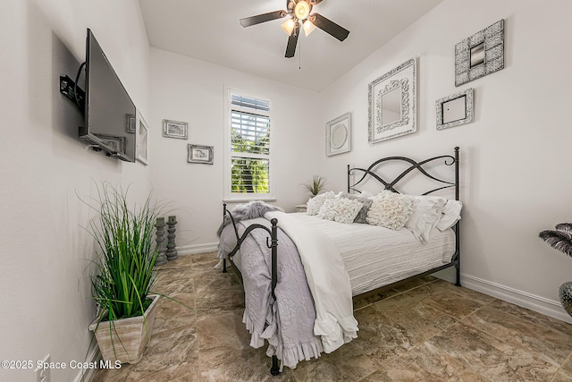 bedroom featuring baseboards and ceiling fan