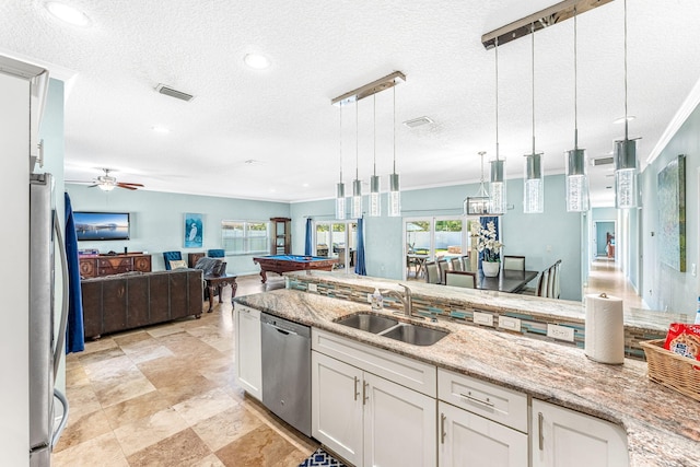 303 Harrison Ave, Cape Canaveral, FL 32920 - kitchen with visible vents, pendant lighting, a sink, open floor plan, and appliances with stainless steel finishes