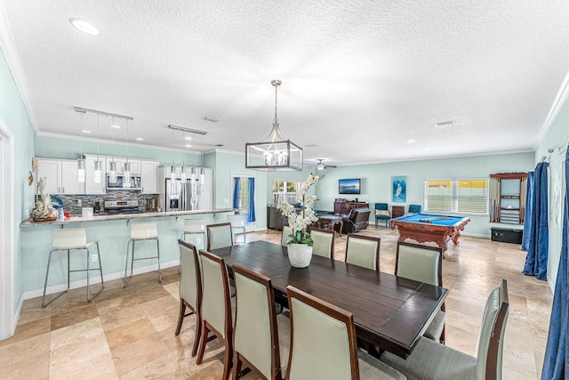 303 Harrison Ave, Cape Canaveral, FL 32920 - dining room with a textured ceiling, pool table, crown molding, and ceiling fan with notable chandelier