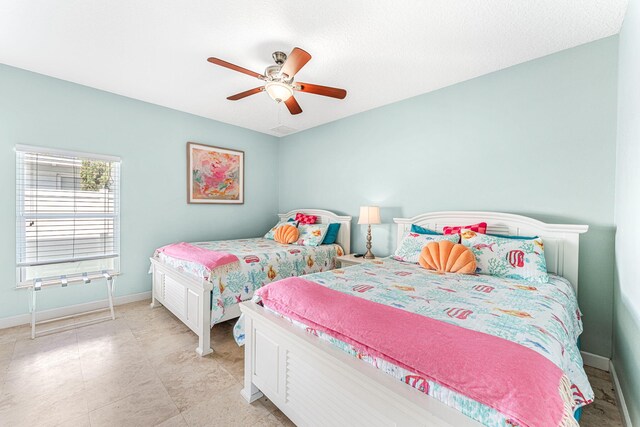 303 Harrison Ave, Cape Canaveral, FL 32920 - bedroom with baseboards and ceiling fan