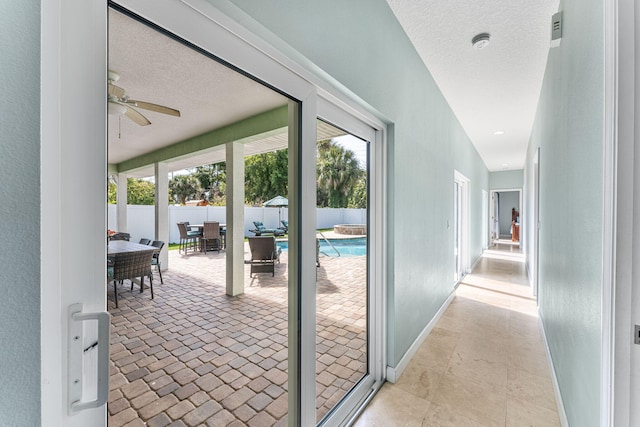 303 Harrison Ave, Cape Canaveral, FL 32920 - hallway featuring baseboards, a sunroom, and a textured ceiling
