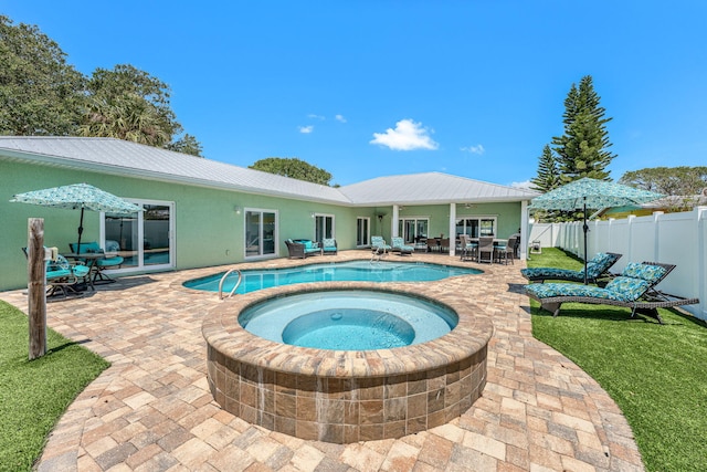 303 Harrison Ave, Cape Canaveral, FL 32920 - view of pool with a fenced in pool, fence, outdoor dining space, an in ground hot tub, and a patio