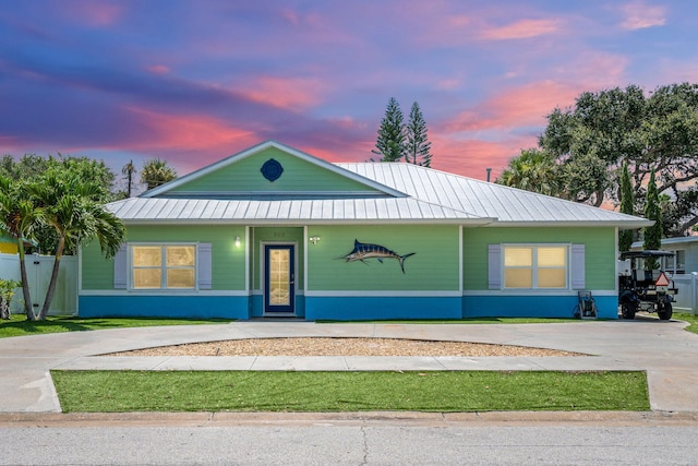 303 Harrison Ave, Cape Canaveral, FL 32920 - view of front of home with concrete driveway, metal roof, and a standing seam roof