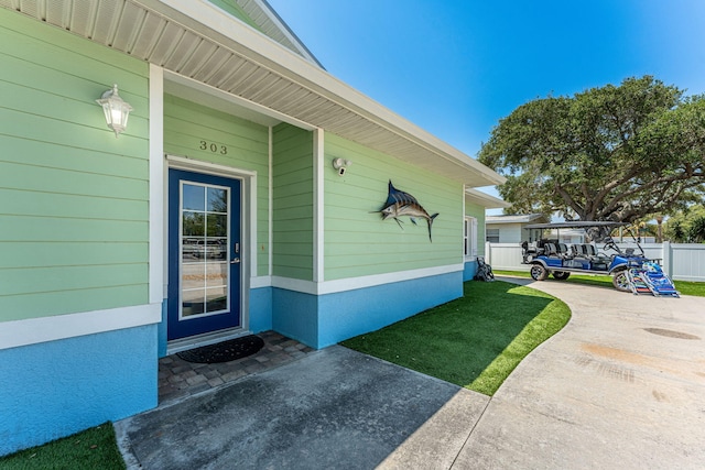 303 Harrison Ave, Cape Canaveral, FL 32920 - doorway to property featuring fence