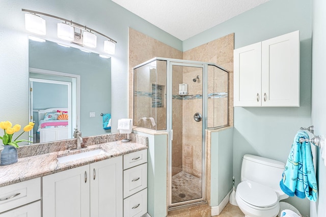 303 Harrison Ave, Cape Canaveral, FL 32920 - full bath featuring vanity, a shower stall, toilet, and a textured ceiling