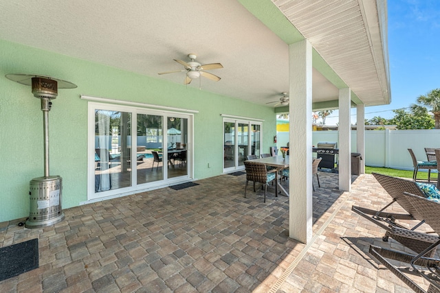 303 Harrison Ave, Cape Canaveral, FL 32920 - view of patio / terrace featuring grilling area, outdoor dining space, a ceiling fan, and fence