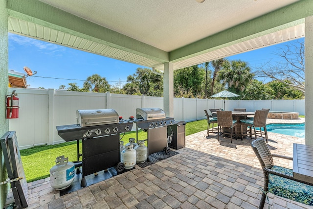 303 Harrison Ave, Cape Canaveral, FL 32920 - view of patio with area for grilling, a fenced in pool, and a fenced backyard