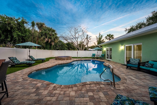 303 Harrison Ave, Cape Canaveral, FL 32920 - pool at dusk featuring a patio, a fenced backyard, and a fenced in pool
