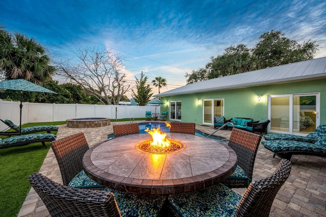 303 Harrison Ave, Cape Canaveral, FL 32920 - view of patio featuring an outdoor living space with a fire pit and a fenced backyard