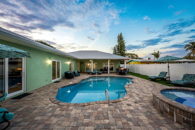 303 Harrison Ave, Cape Canaveral, FL 32920 - view of swimming pool featuring an in ground hot tub, fence, a fenced in pool, and a patio