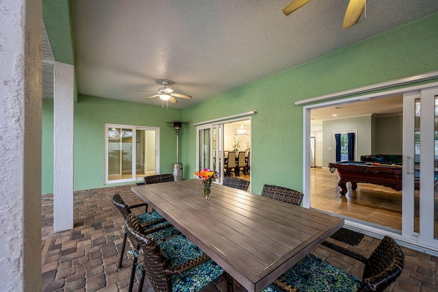 303 Harrison Ave, Cape Canaveral, FL 32920 - interior space with a textured ceiling, a ceiling fan, brick floor, and a textured wall