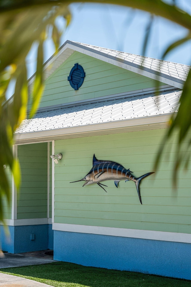 303 Harrison Ave, Cape Canaveral, FL 32920 - view of side of property featuring metal roof