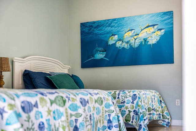 303 Harrison Ave, Cape Canaveral, FL 32920 - bedroom featuring baseboards and wood finished floors