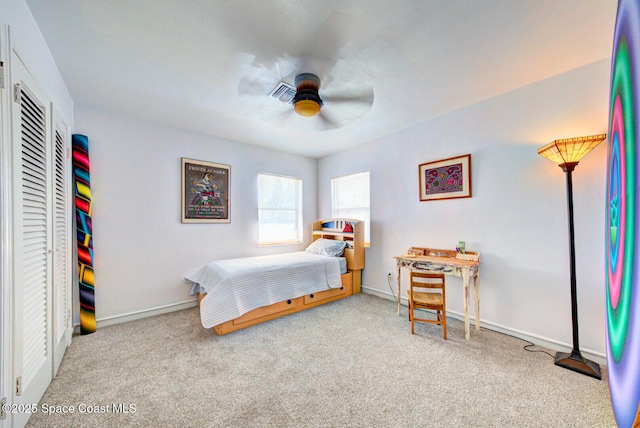 carpeted bedroom with a ceiling fan, visible vents, and baseboards