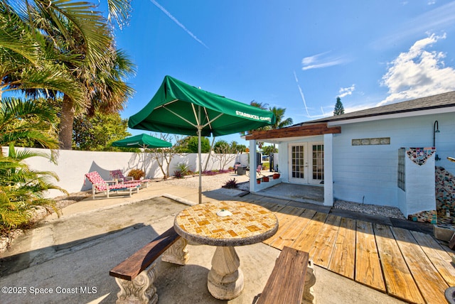 view of patio with french doors and a fenced backyard