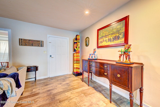 foyer featuring baseboards, wood finished floors, and recessed lighting