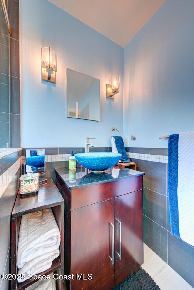 bathroom with tile walls and vanity