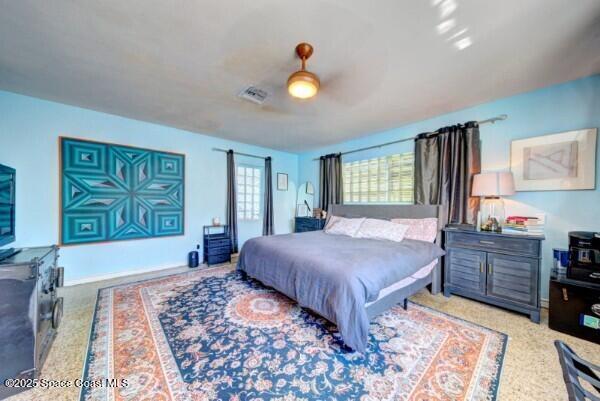 bedroom with visible vents and a ceiling fan