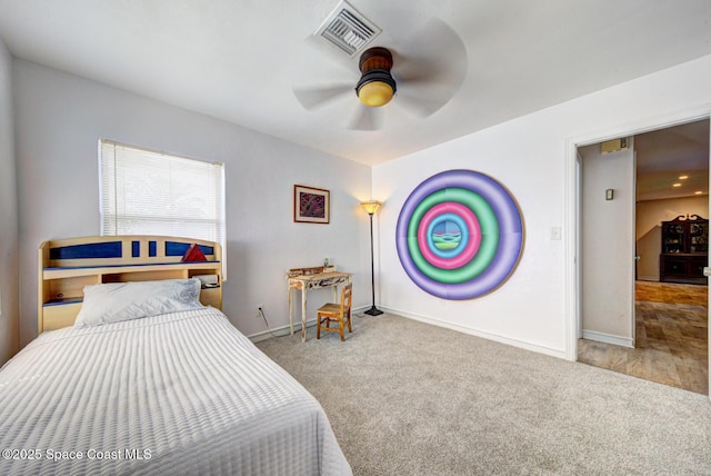 bedroom with carpet floors, baseboards, visible vents, and a ceiling fan