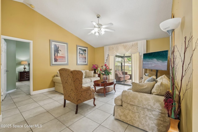 living area featuring a ceiling fan, lofted ceiling, baseboards, and light tile patterned floors