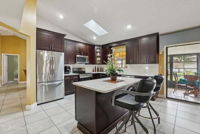 kitchen with plenty of natural light, stainless steel appliances, light tile patterned flooring, and light countertops