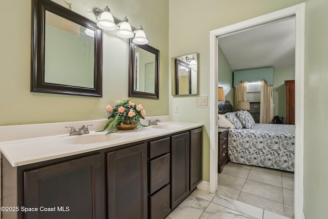 full bathroom featuring marble finish floor, double vanity, a sink, and ensuite bathroom