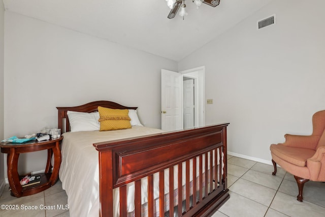 bedroom featuring light tile patterned flooring, visible vents, baseboards, vaulted ceiling, and a ceiling fan