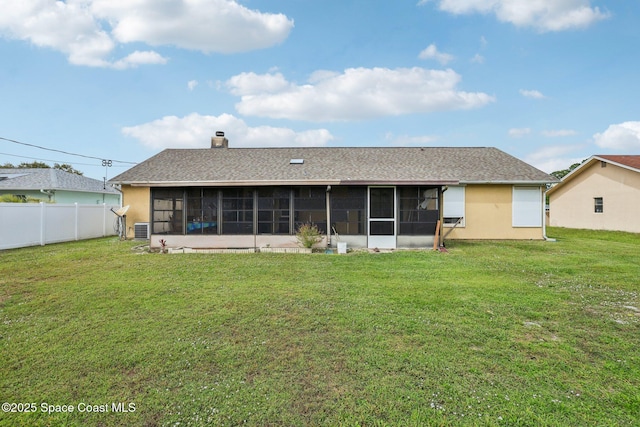 back of property featuring cooling unit, a sunroom, a lawn, and fence