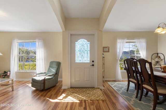 foyer with wood finished floors and baseboards