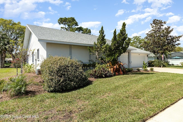 single story home with a garage, a front yard, a shingled roof, and stucco siding