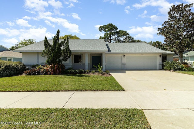 ranch-style home with concrete driveway, roof with shingles, an attached garage, and a front yard