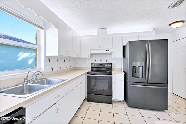 kitchen with stainless steel refrigerator with ice dispenser, electric range, white cabinetry, a sink, and under cabinet range hood