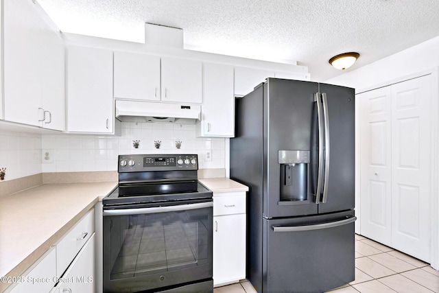 kitchen with black / electric stove, under cabinet range hood, white cabinets, light countertops, and stainless steel fridge