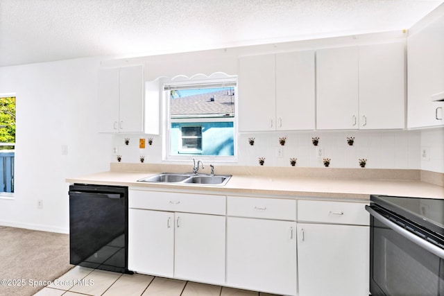 kitchen with black appliances, light countertops, and a wealth of natural light