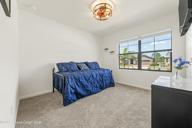 bedroom with carpet flooring and baseboards