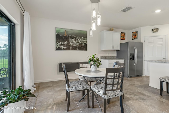 dining area featuring visible vents and baseboards