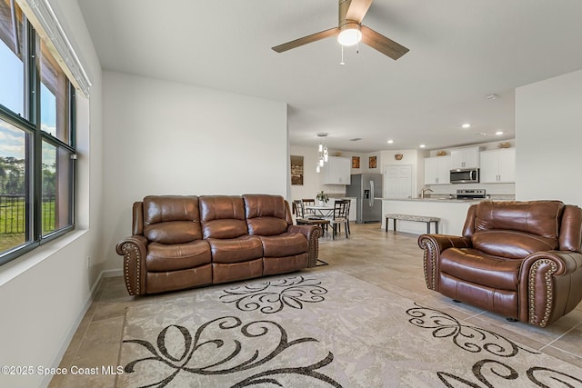 living room with recessed lighting, light tile patterned flooring, ceiling fan, and baseboards